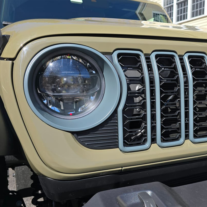 Close-up of a Jeep 24' Mopar front grille trim and headlight