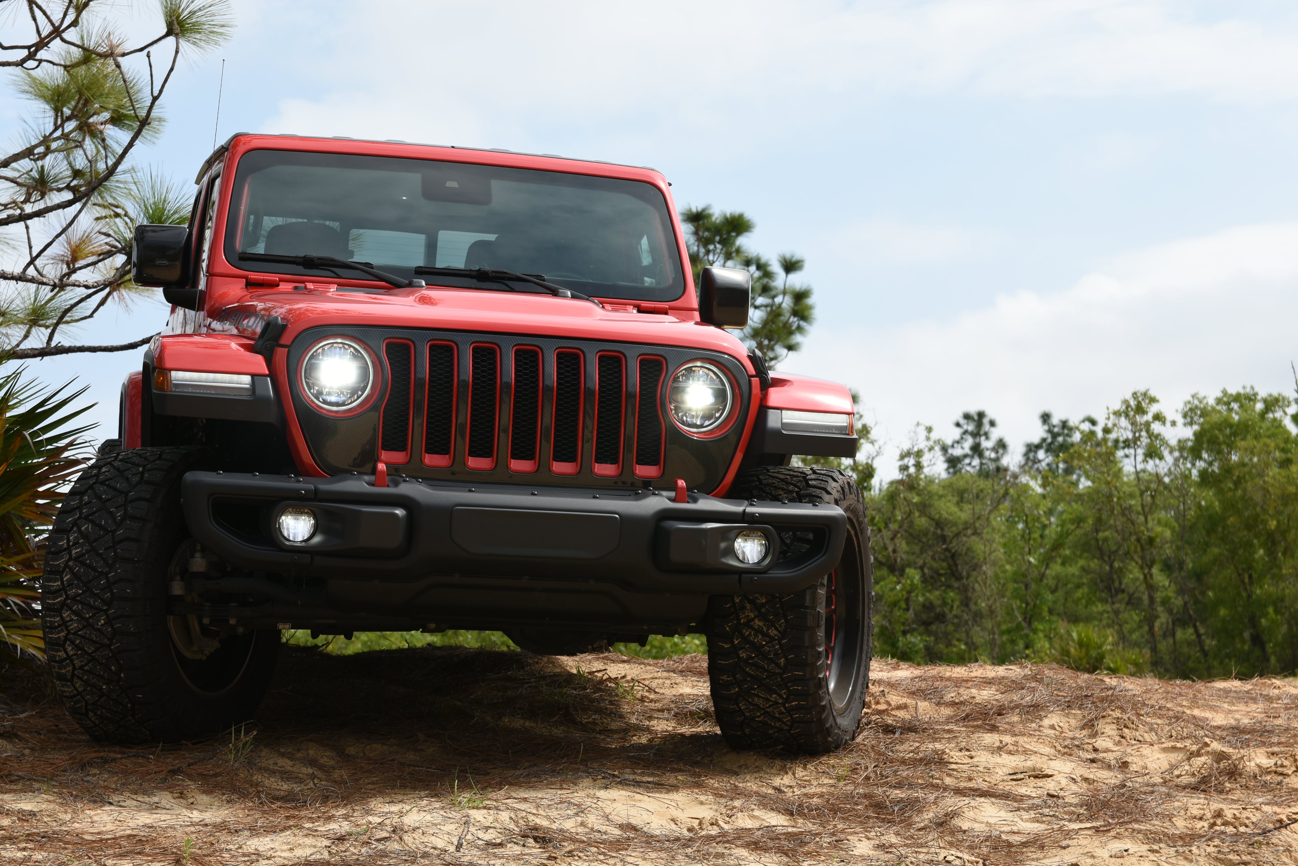 Wrangler JL in Black and Firecracker Red on a sandy dune