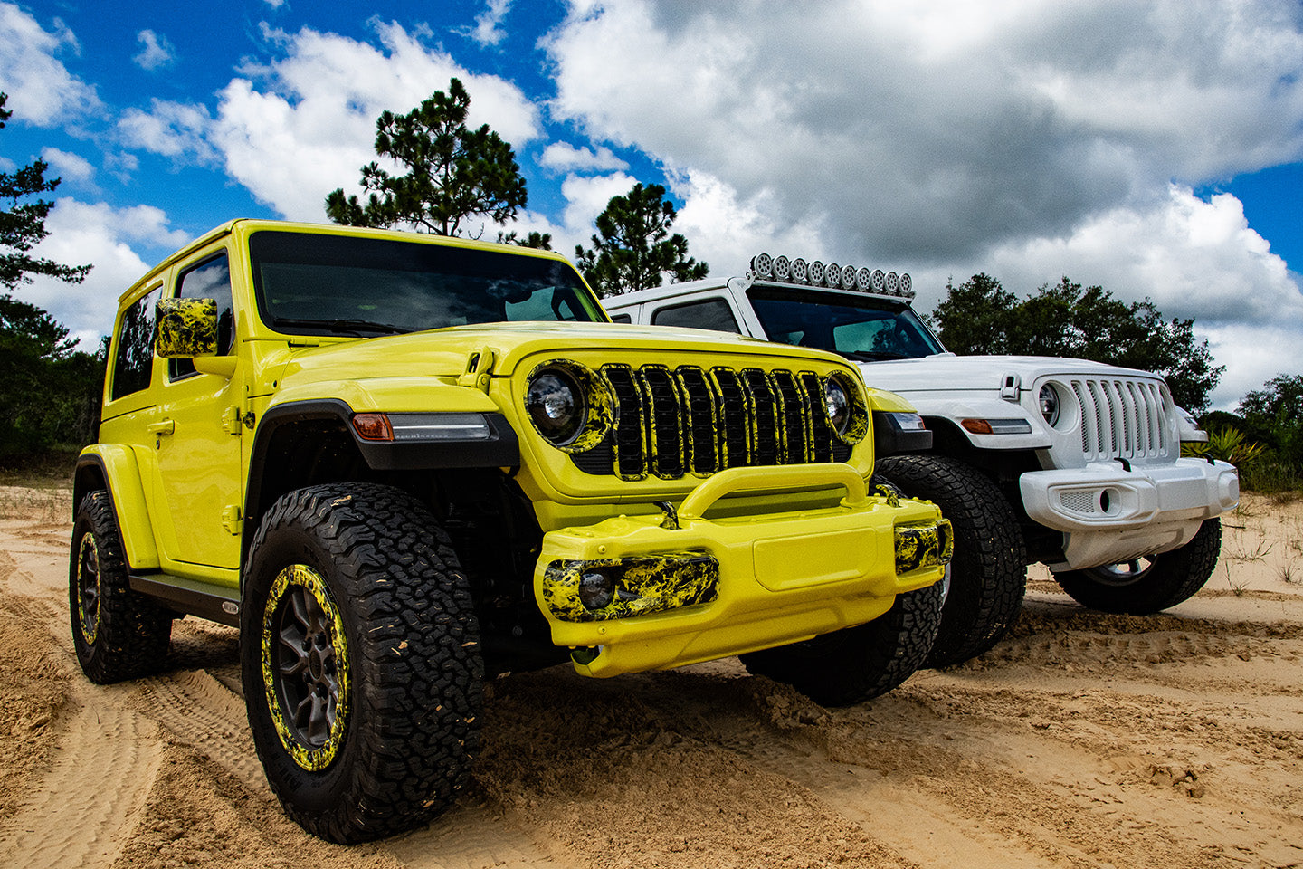 yellow and white jeep side by side on sand dunes