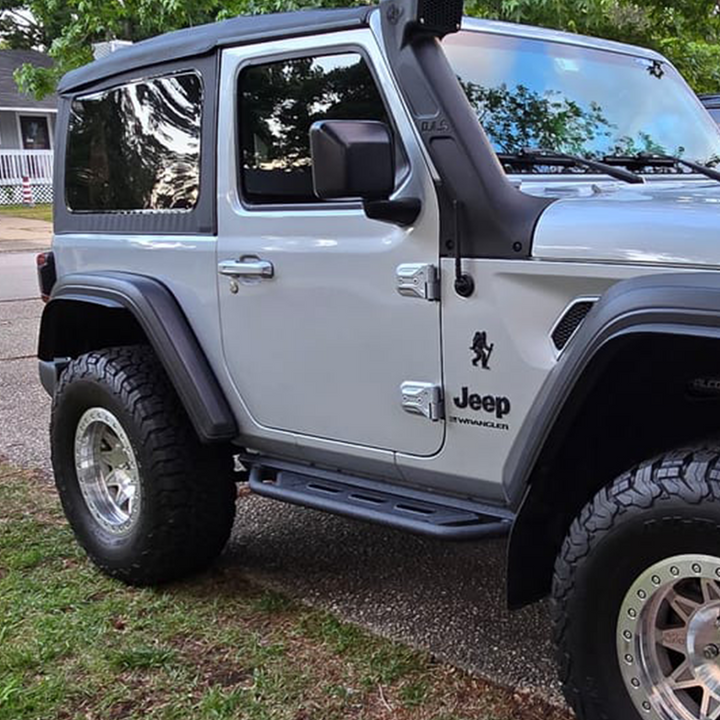 Wrangler JL Silver Zynith Jeep with paint-matched standard entry door handles in gloss finish  parked on a driveway with grass and a house in the background