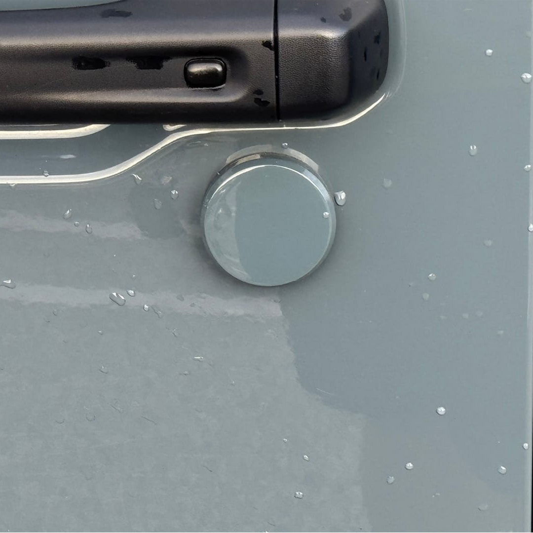 Close-up of a painted cover'd-up keyhole cover in Anvil on a Jeep Wrangler 