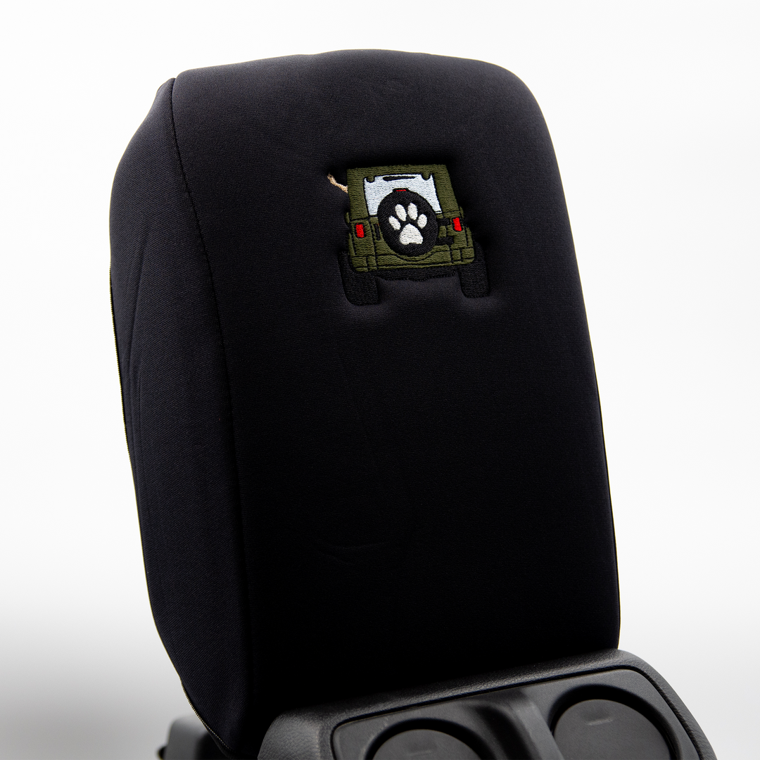 Black console cover with army green color-matched Jeep rear end and black tire cover with white paw print 
