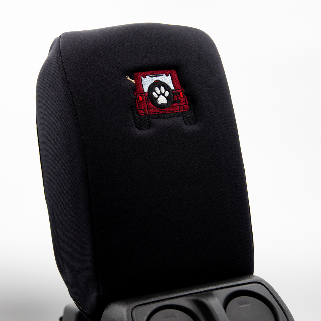Black console cover with deep red color-matched Jeep rear end and black tire cover with white paw print 