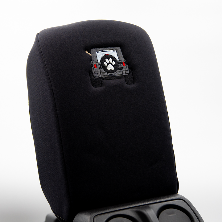 Black console cover with gray color-matched Jeep rear end and black tire cover with white paw print 