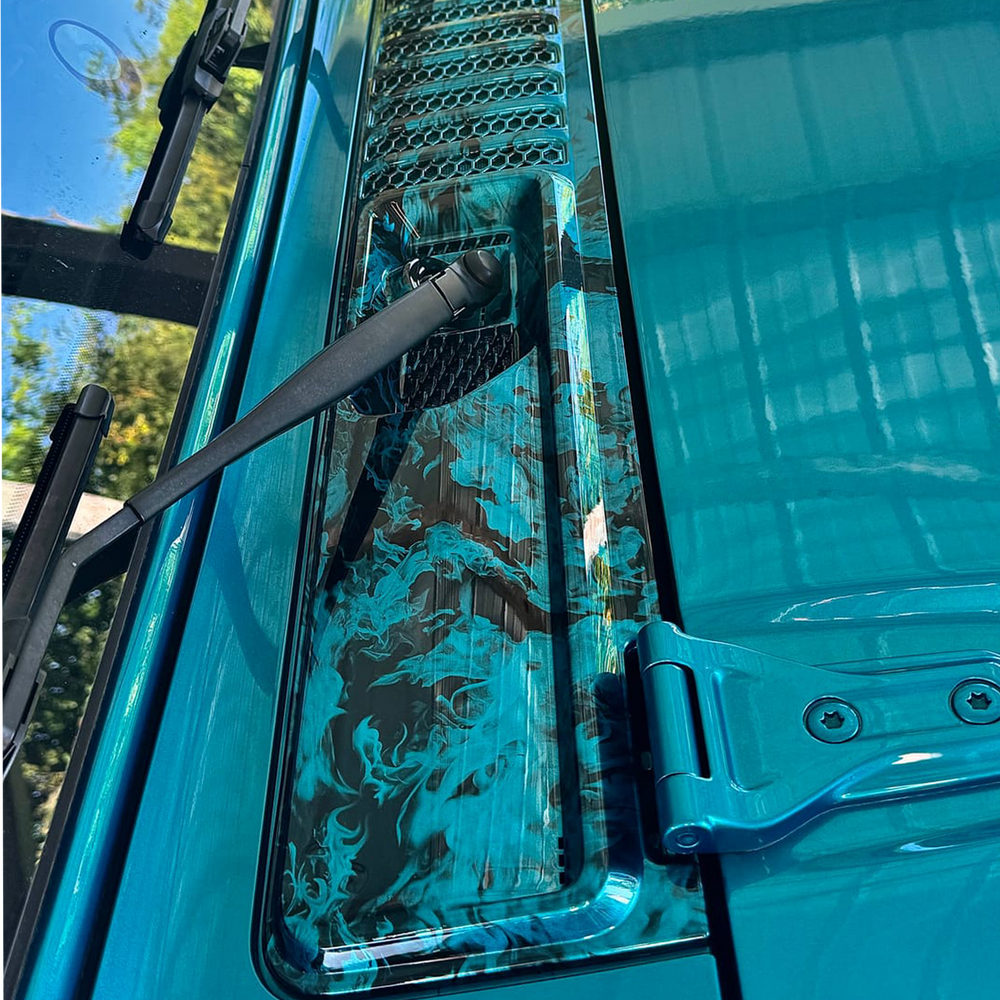 Close-up of a bikini blue Jeep cowl wiper panel with naughty fire graphic painted by Distinction Applied