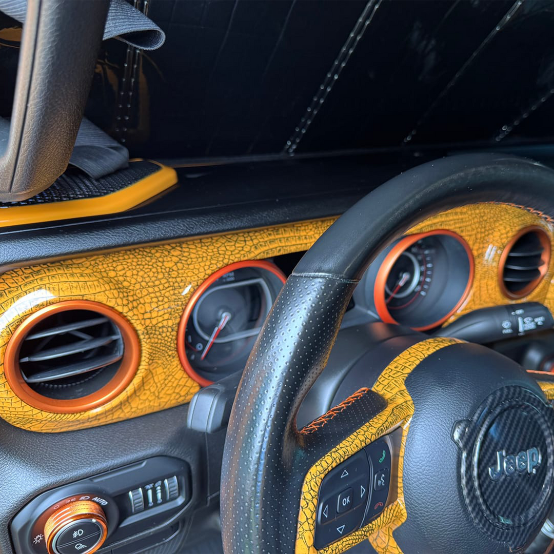 Close-up of a Wrangler JL interior with Nacho OEM paint matched Dash Panel AC Trim rings with gator graphic dash panel 