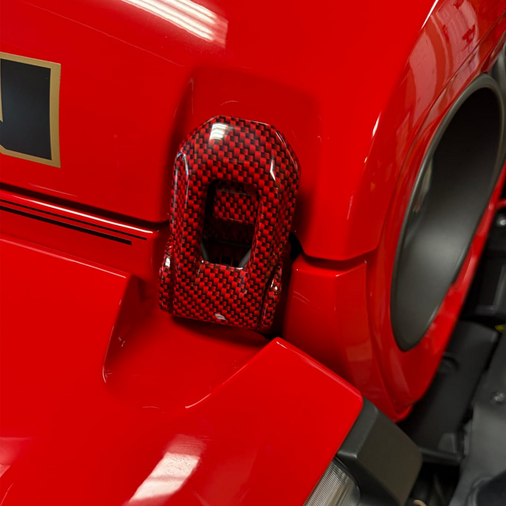 Black Carbon Graphic and Firecracker Red Hood Latch on Red Jeep