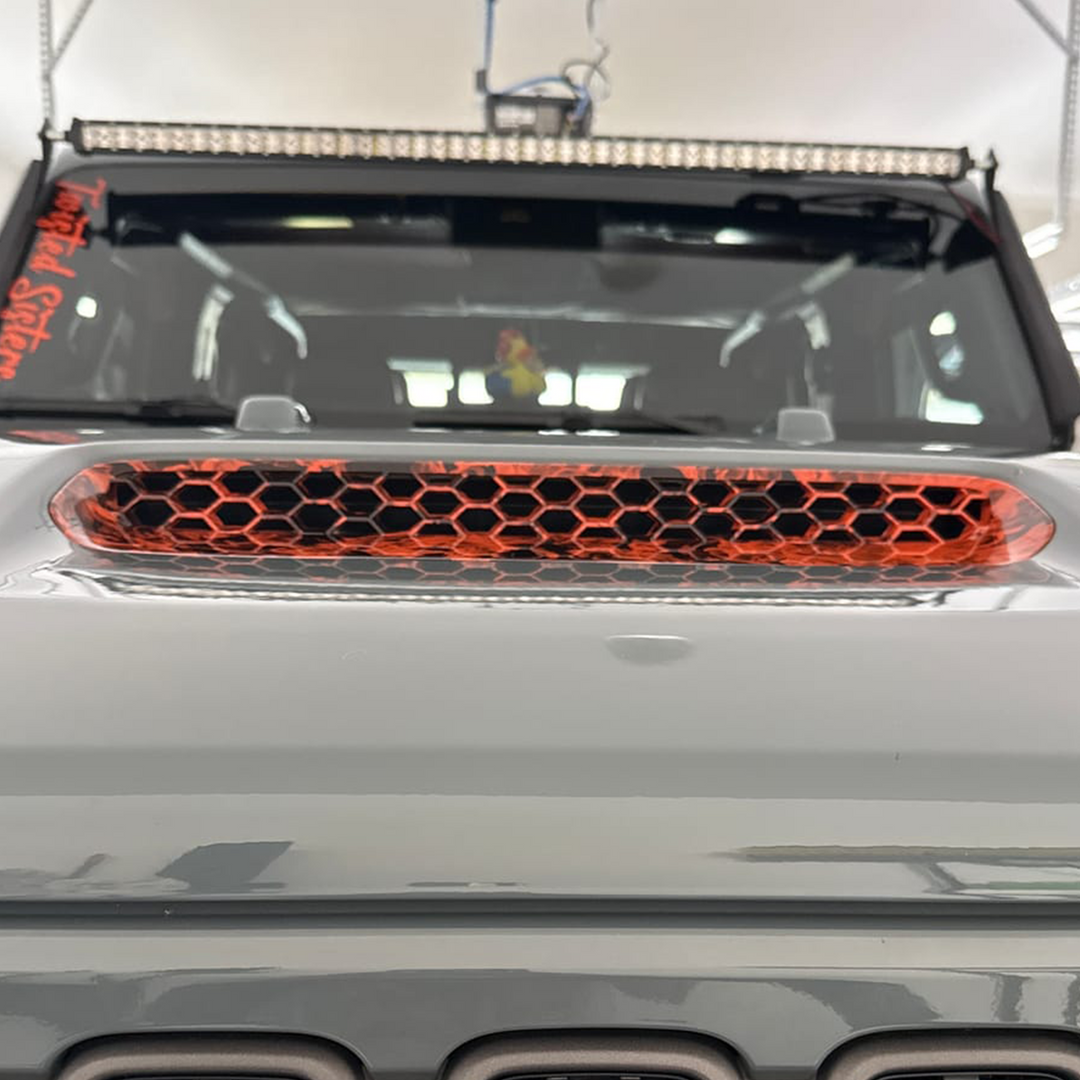 Close-up of a JT Gladiator Mojave with  Mojave orange and naughty fire graphic hood vent 