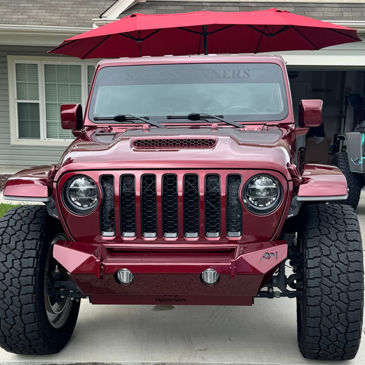 Snazzberry Pearl Gladiator JT with color matched Hood Vent parked under a red umbrella on a driveway.