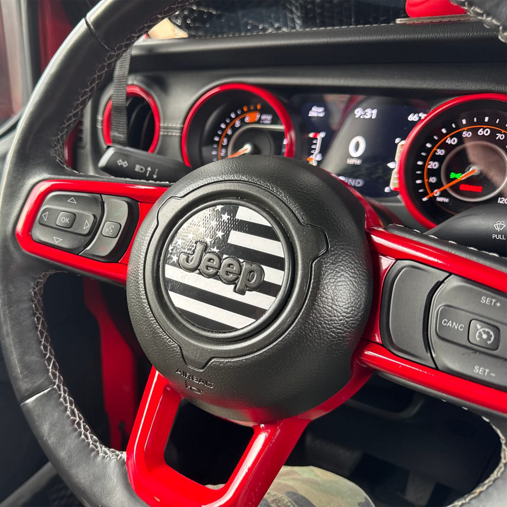 Close-up of a Jeep steering wheel with trim painted in Firecracker Red 