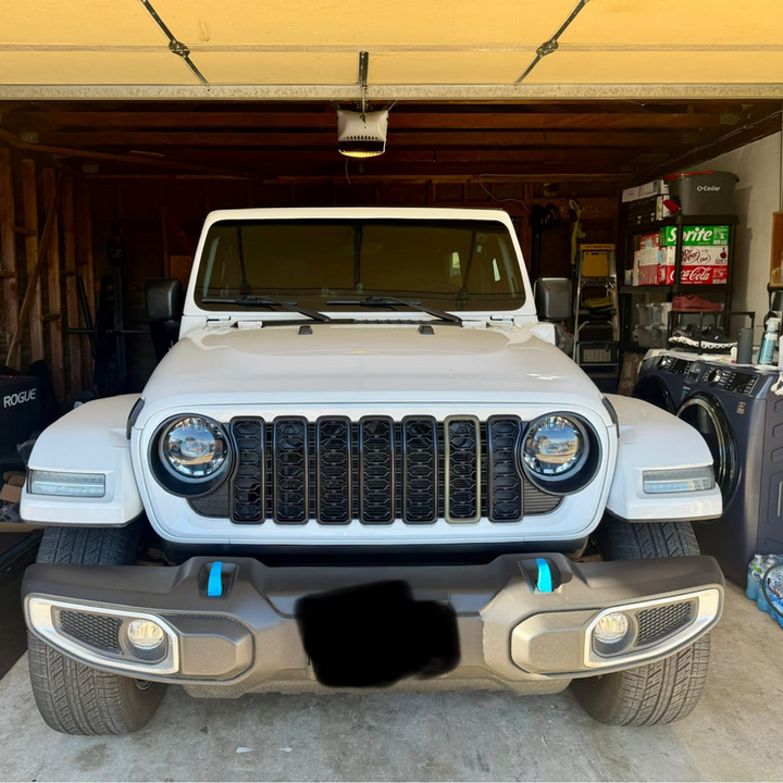 JL Jeep parked inside a garage with Bright White grille, surround, 41 color painted trim slot and black trim and mesh on '24 Aftermarket Grille