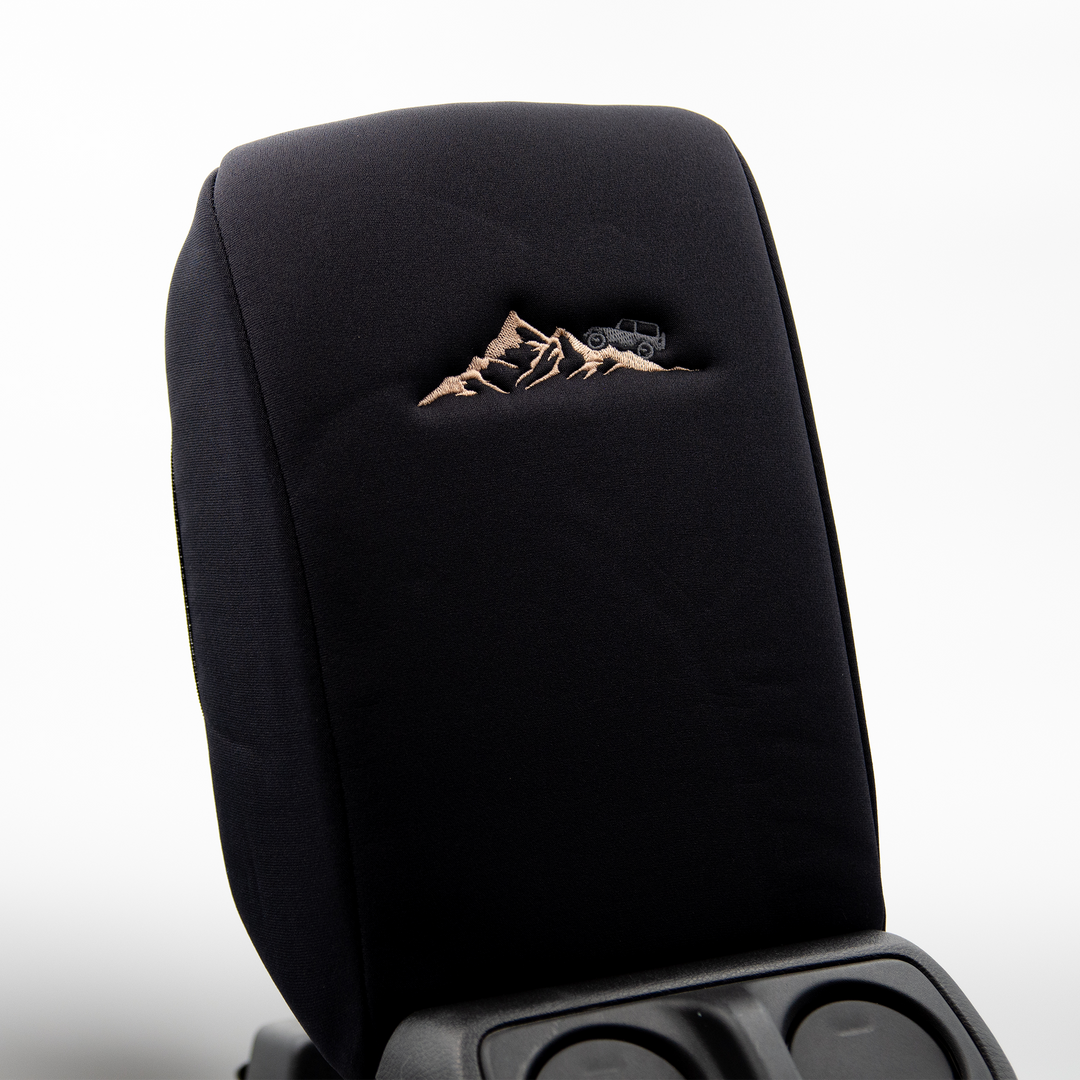 Black console cover with gray jeep on mountain 