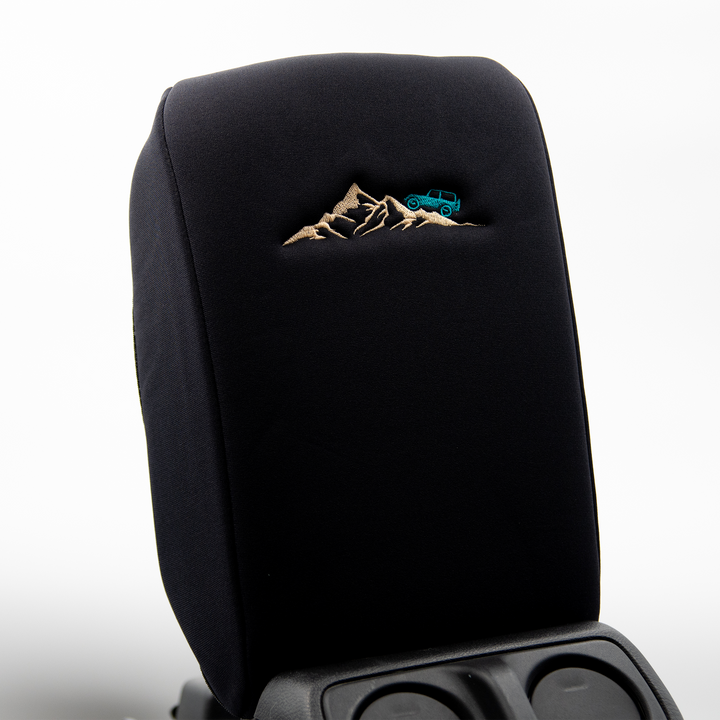 Black console cover with teal jeep on mountain 