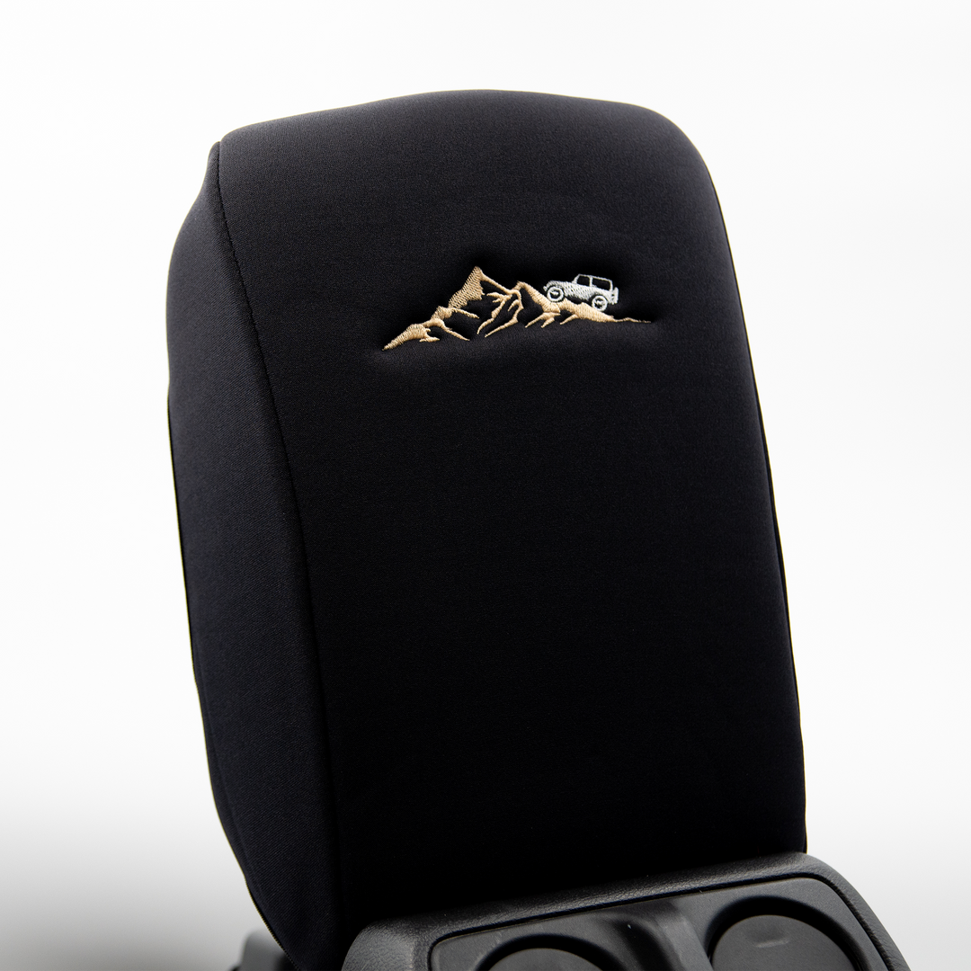 Black console cover with white jeep on mountain 