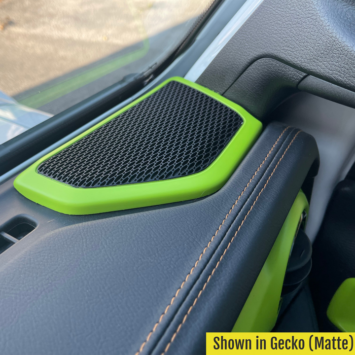 Gecko OE color-painted speaker cover in matte finish,  for the Jeep's front dashboard, displayed inside the vehicle, showing the speaker mesh.