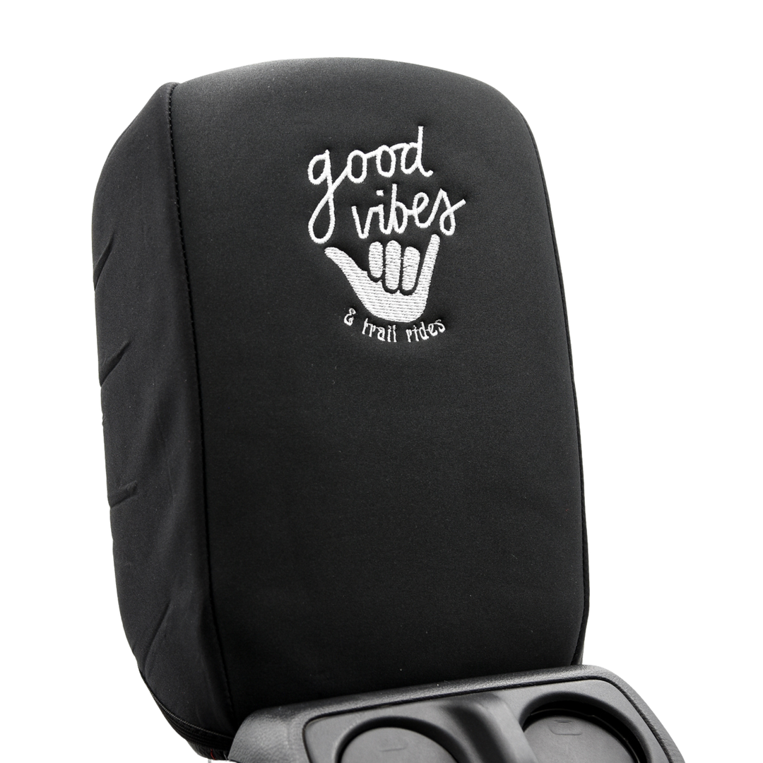 Black console cover with 'good vibes & trail rides' text, and surfer hand wave on a white background