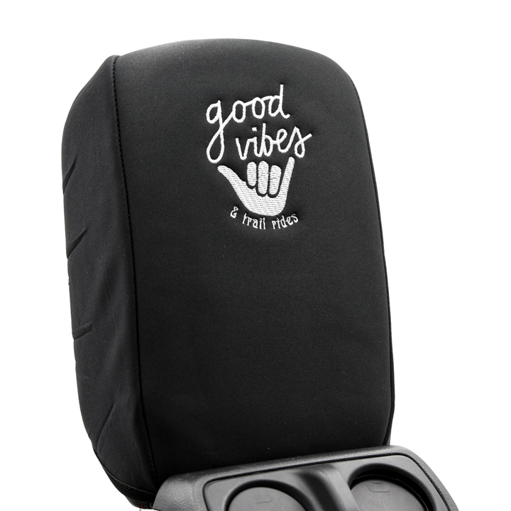 Black console cover with 'good vibes & trail rides' text, and surfer hand wave on a white background