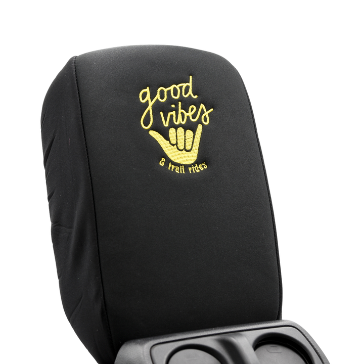 Black console cover  with yellow 'good vibes & tall rides' text with surfer hand wave on a white background