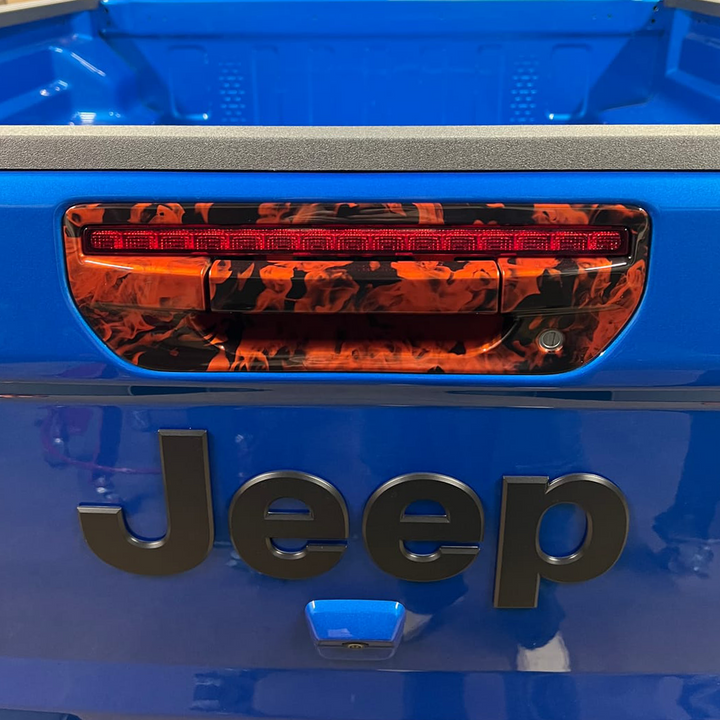 Close-up of Gladiator JT tailgate handle with Joose/Crush base color and naughty fire hydrographic pattern.