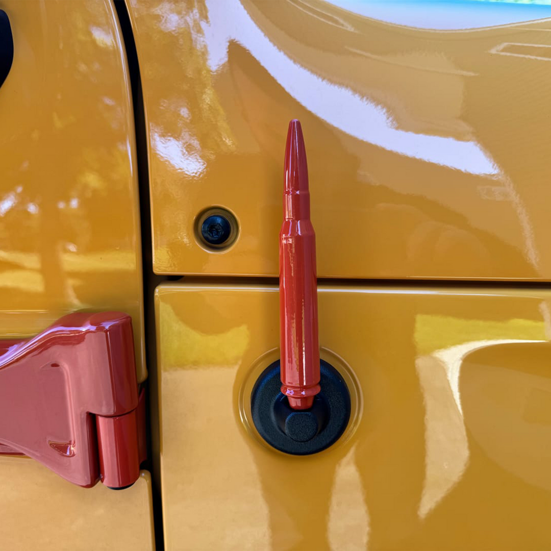 Close-up of a Mojave-orange painted 50 caliber aftermarket bullet antenna with Cover'd Up color-matched door handles.