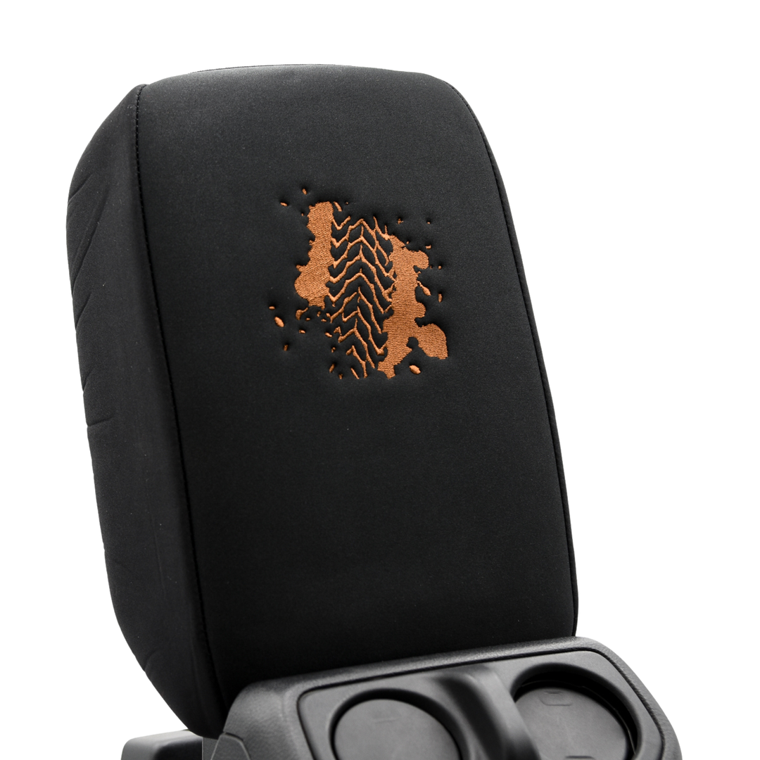 Black console cover with a brown tire tread pattern on a white background