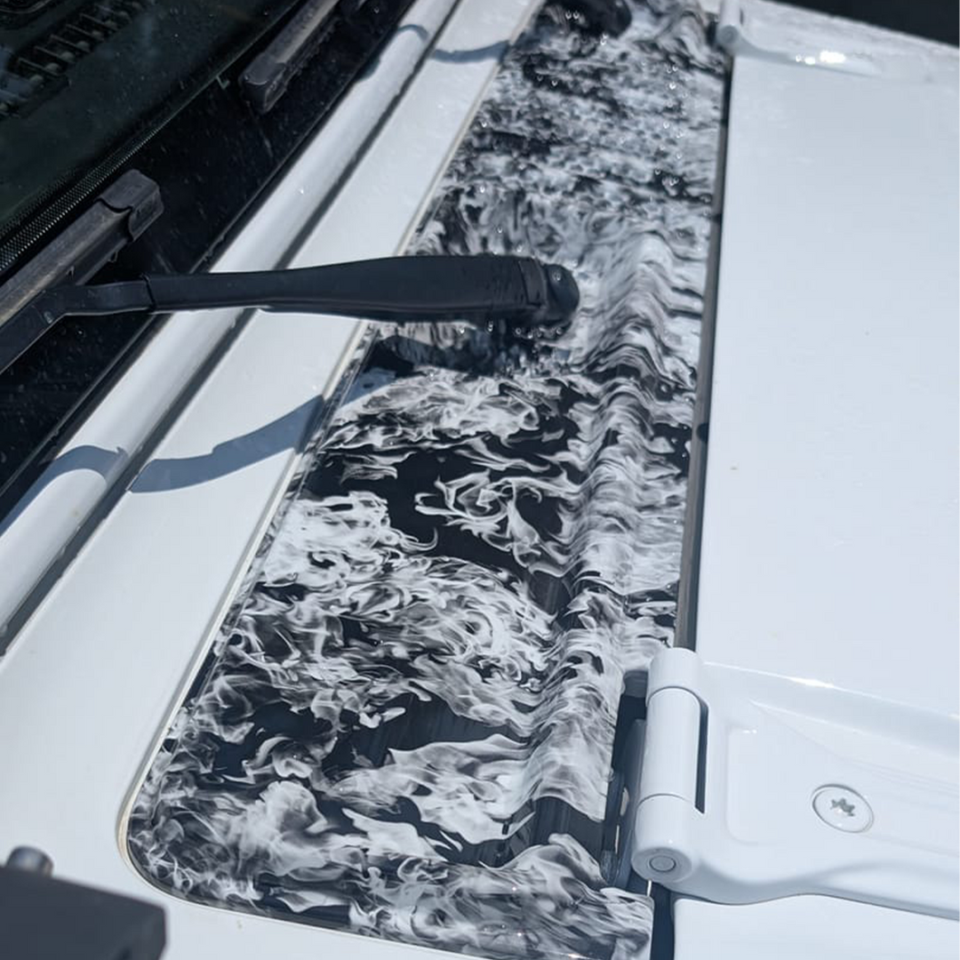 Close-up of a cowl wiper panel painted in white and naughty fire graphic pattern
