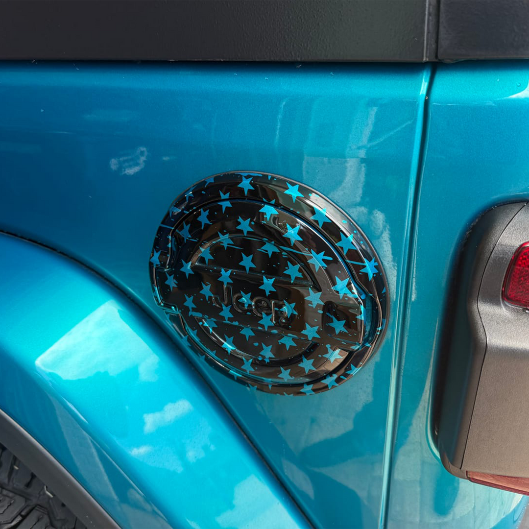 Close-up of a Wrangler JL Jeep with a tattered flag-patterned gas cap with Bikini Pearl OEM overlay by Distinction Applied.